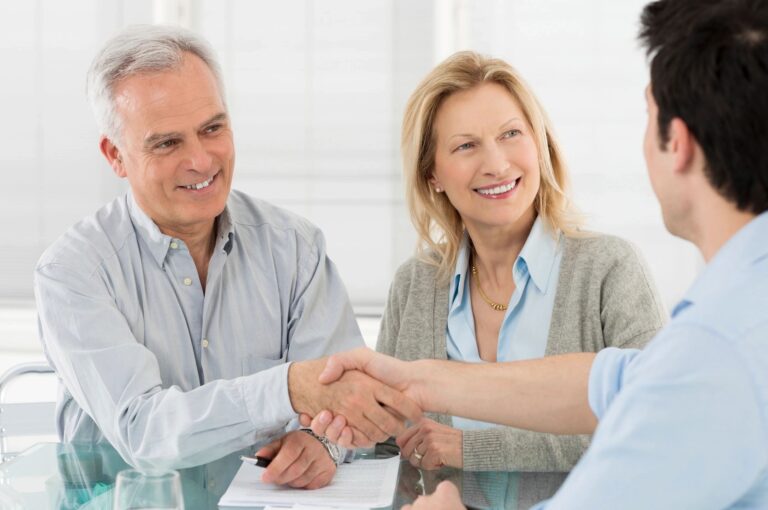 Couple meeting with financial advisor discussing January 2026 retirement planning and IRA contributions