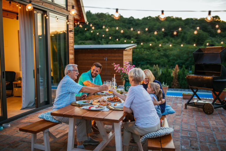 multi-gen family eating dinner on patio